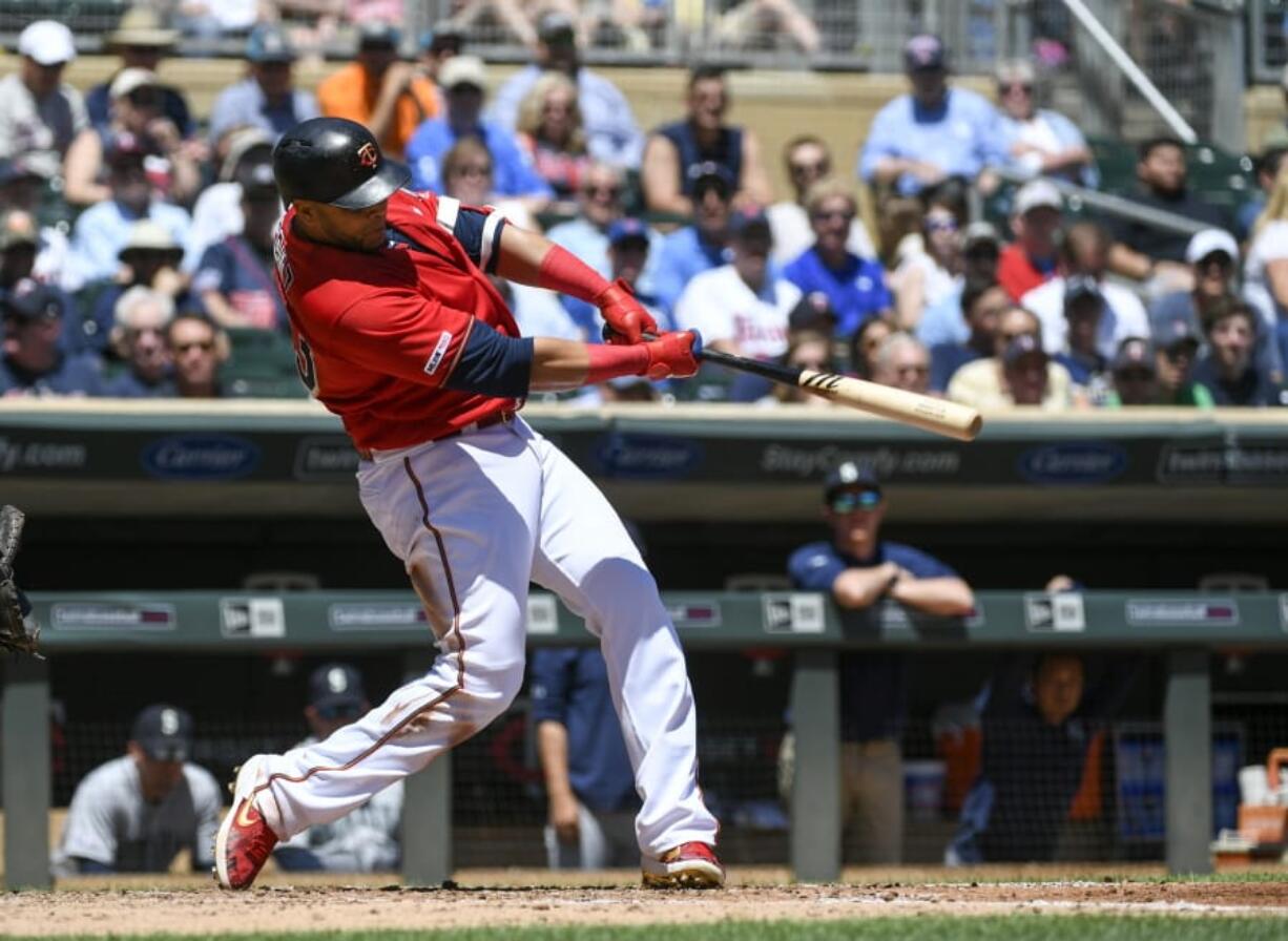 Minnesota Twins designated hitter Nelson Cruz hits a solo home run off a pitch by Seattle Mariners pitcher Yusei Kikuchi during the third inning of a baseball game, Thursday, June 13, 2019, in Minneapolis.