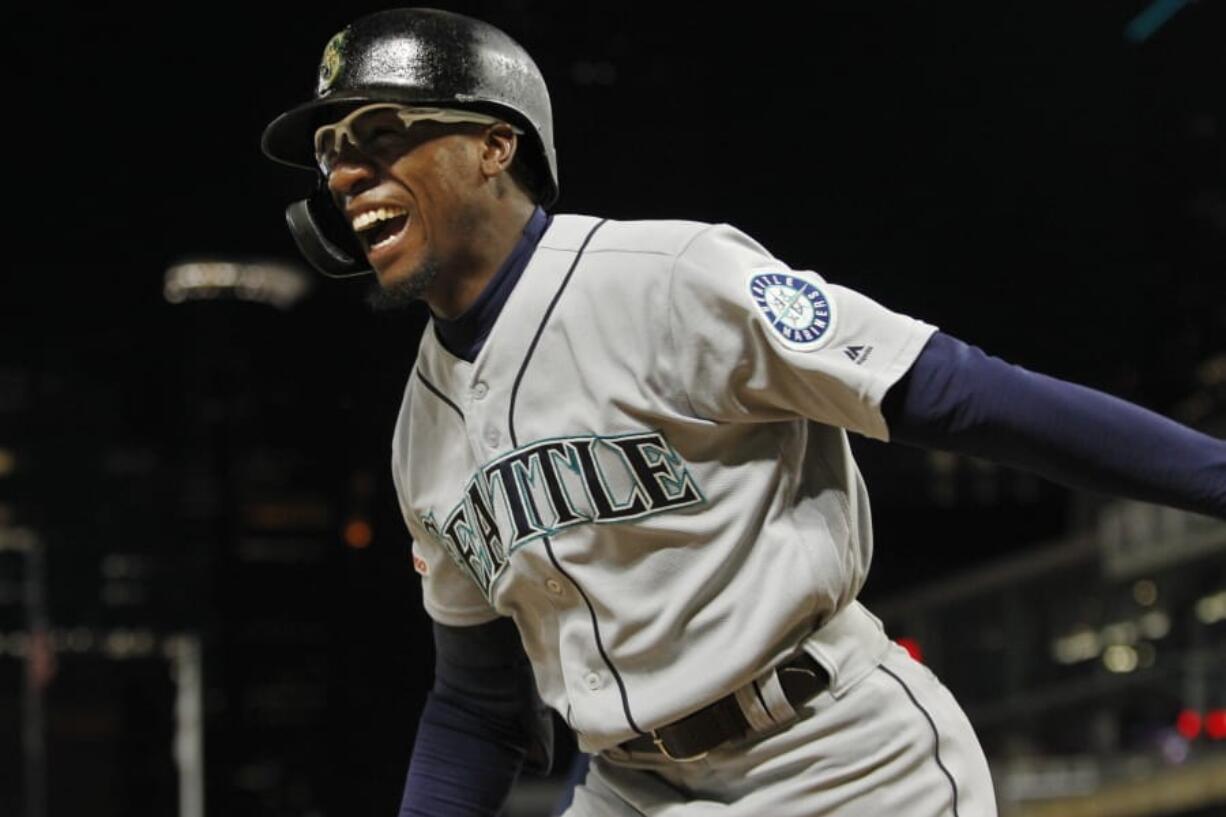 Seattle Mariners’ Shed Long celebrates his three-run home run against the Minnesota Twins during the eighth inning of a baseball game Wednesday, June 12, 2019, in Minneapolis.