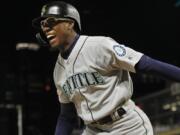 Seattle Mariners’ Shed Long celebrates his three-run home run against the Minnesota Twins during the eighth inning of a baseball game Wednesday, June 12, 2019, in Minneapolis.