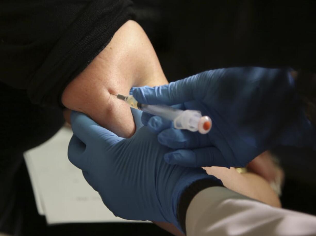 FILE - In this March 27, 2019 file photo, a woman receives a measles, mumps and rubella vaccine at the Rockland County Health Department in Pomona, N.Y., north of New York City. On Wednesday, June 5, 2019, federal health officials updated the U.S. measles case count, saying 1,001 illnesses have been reported since the beginning of the year.