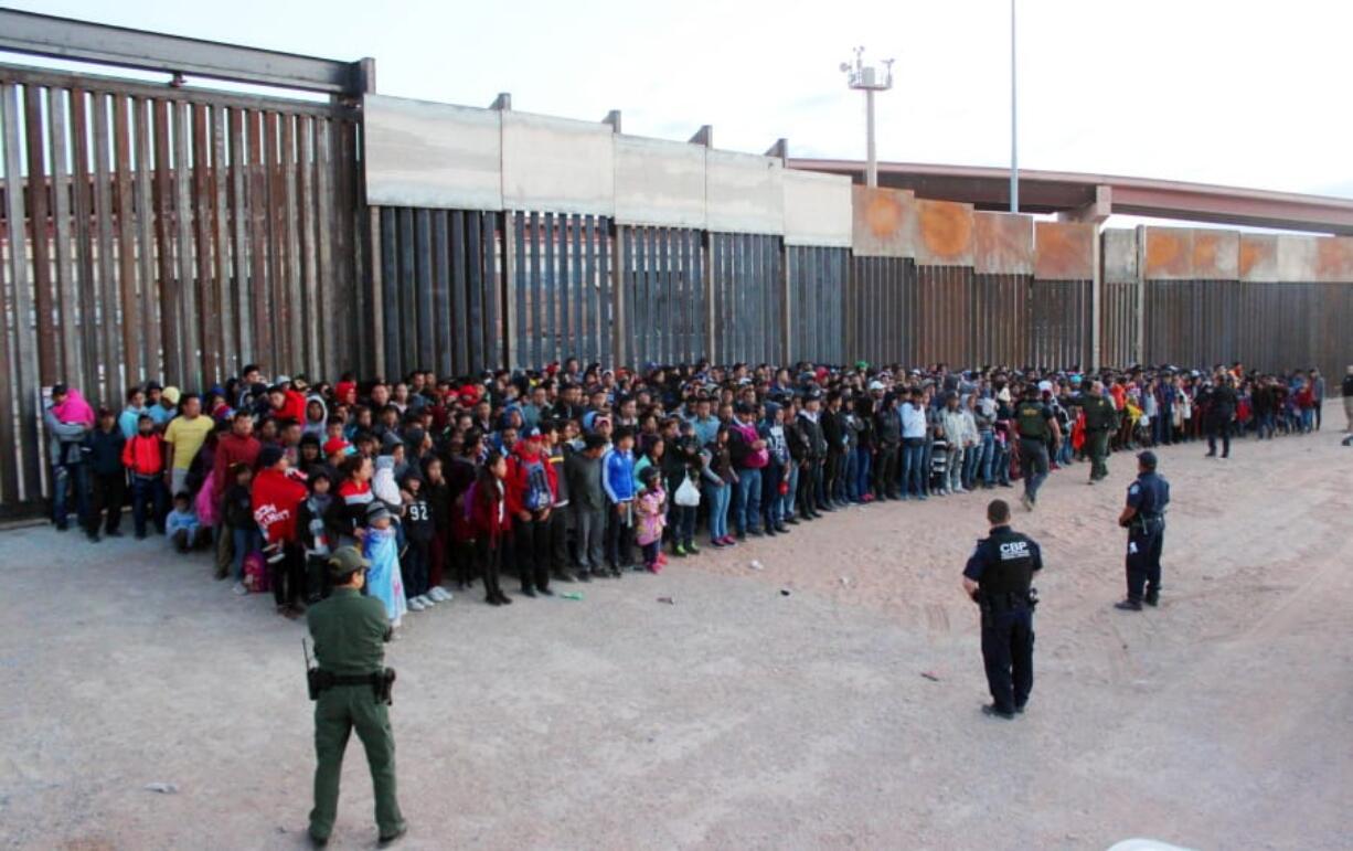 FILE - This May 29, 2019 file photo released by U.S. Customs and Border Protection (CBP) shows some of 1,036 migrants who crossed the U.S.-Mexico border in El Paso, Texas, the largest that the Border Patrol says it has ever encountered. The federal government is opening a new mass shelter for migrant children near the U.S-Mexico border and is considering housing children on three military bases to add 3,000 more beds to the overtaxed system in the coming weeks. (U.S.