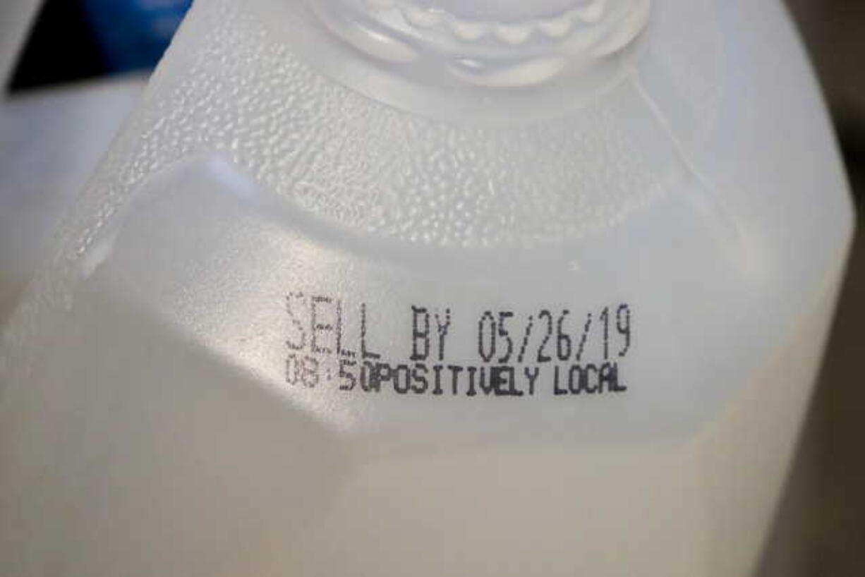 This Friday, May 24, 2019 photo shows the “sell by” date for a jug of milk in New York. In May 2019, U.S. regulators are again urging food makers to reduce the variety of terms like “best by” and “use by” that cause confusion about when food should be thrown out.