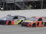 Alex Bowman, left, and Martin Truex Jr., compete during a NASCAR Cup Series auto race at Chicagoland Speedway in Joliet, Ill., Sunday, June 30, 2019. (AP Photo/Nam Y.