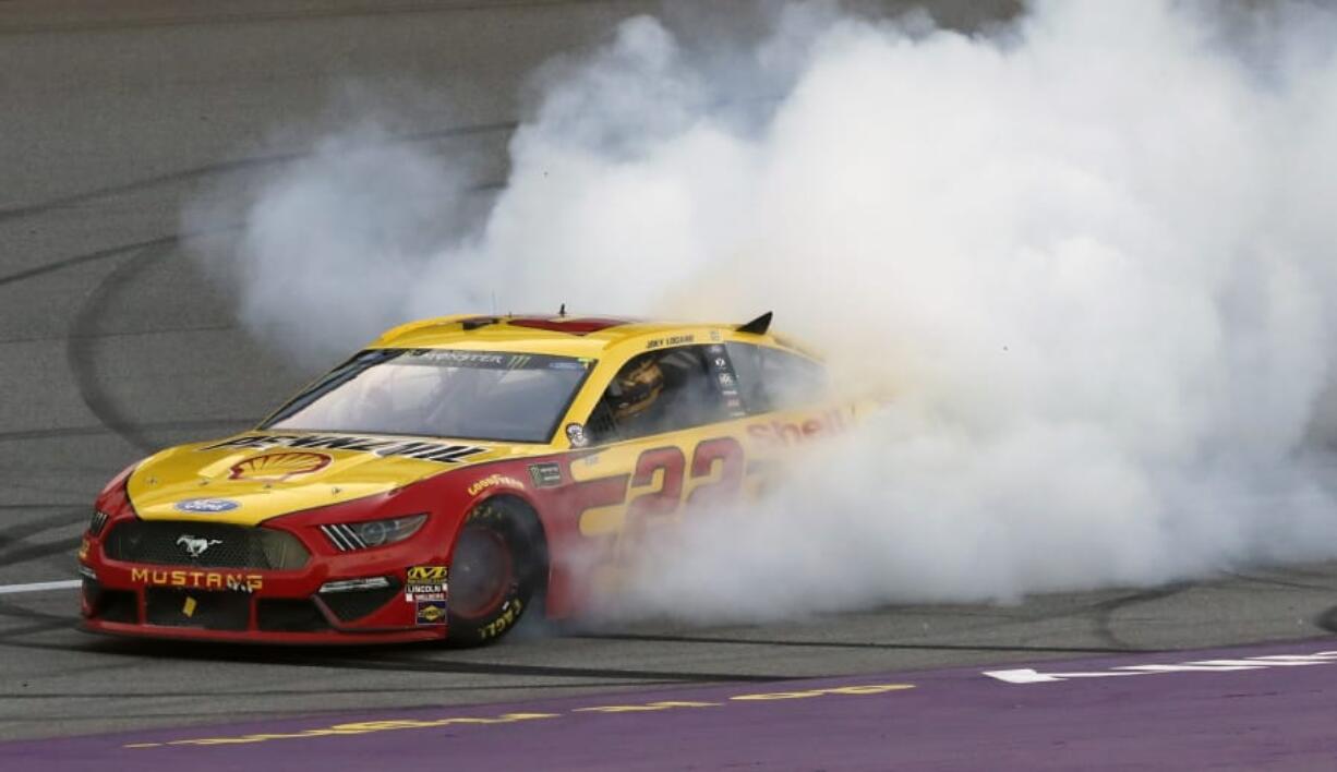 Joey Logano celebrates with a burnout after winning a NASCAR Cup Series auto race at Michigan International Speedway, Monday, June 10, 2019, in Brooklyn, Mich.