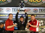 Greg Biffle raises the trophy after winning the NASCAR Truck Series auto race at Texas Motor Speedway in Fort Worth, Texas, Friday, June 7, 2019.