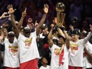 Toronto Raptors guard Kyle Lowry, center right, holds Larry O’Brien NBA Championship Trophy after the Raptors defeated the Golden State Warriors 114-110 in Game 6 of basketball’s NBA Finals, Thursday, June 13, 2019, in Oakland, Calif.