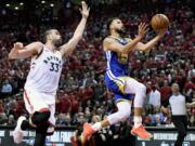 Golden State Warriors guard Stephen Curry (30) drives to the net as Toronto Raptors center Marc Gasol (33) looks on during the first half of Game 2 of basketball’s NBA Finals, Sunday, June 2, 2019, in Toronto.