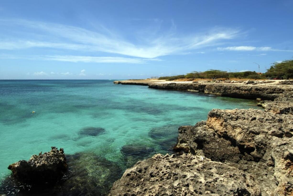 In this April 2008 file photo, crystal clear water meets the shore in Aruba. Aruba offers a sun-drenched Caribbean escape outside the hurricane belt, making this island retreat an irresistible option for late-summer travelers.