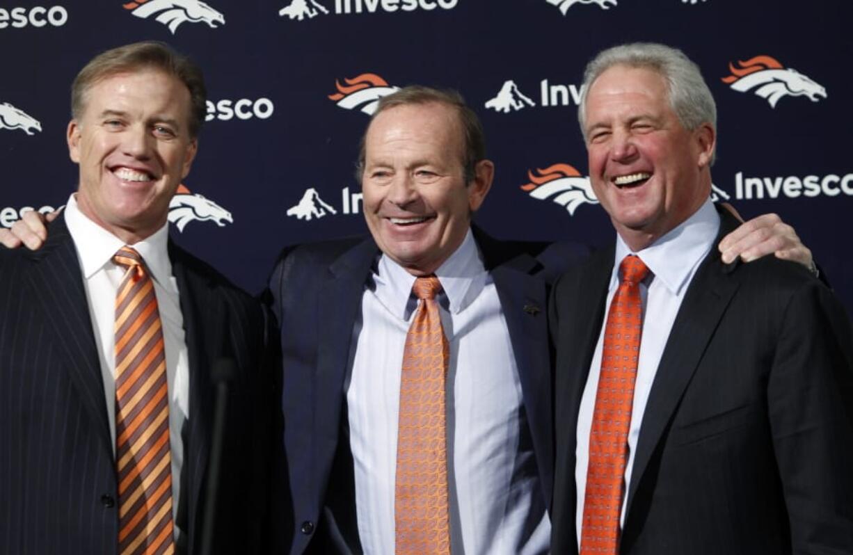 Denver Broncos NFL football team owner Pat Bowlen is flanked by John Elway, left, Executive V.P. of football operations and John Fox, head coach, at the teams headquarters in 2011 at  Englewood, Colo.