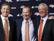 Denver Broncos NFL football team owner Pat Bowlen is flanked by John Elway, left, Executive V.P. of football operations and John Fox, head coach, at the teams headquarters in 2011 at  Englewood, Colo.