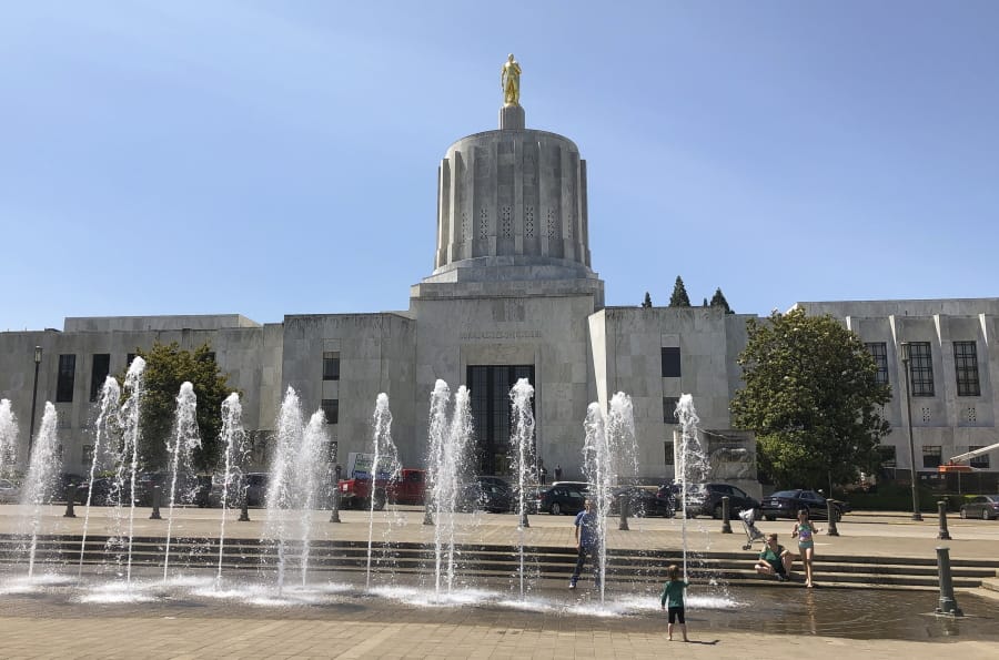 Children play in fountains at the Oregon State Capitol while inside the Senate meets after a boycott by Republican lawmakers over a climate-change bill ended, in Salem, Ore., Saturday, June 29, 2019. Nine of the 12 minority Republicans returned after Senate President Peter Courtney said the majority Democrats lacked the votes to pass the legislation aimed at countering climate change.