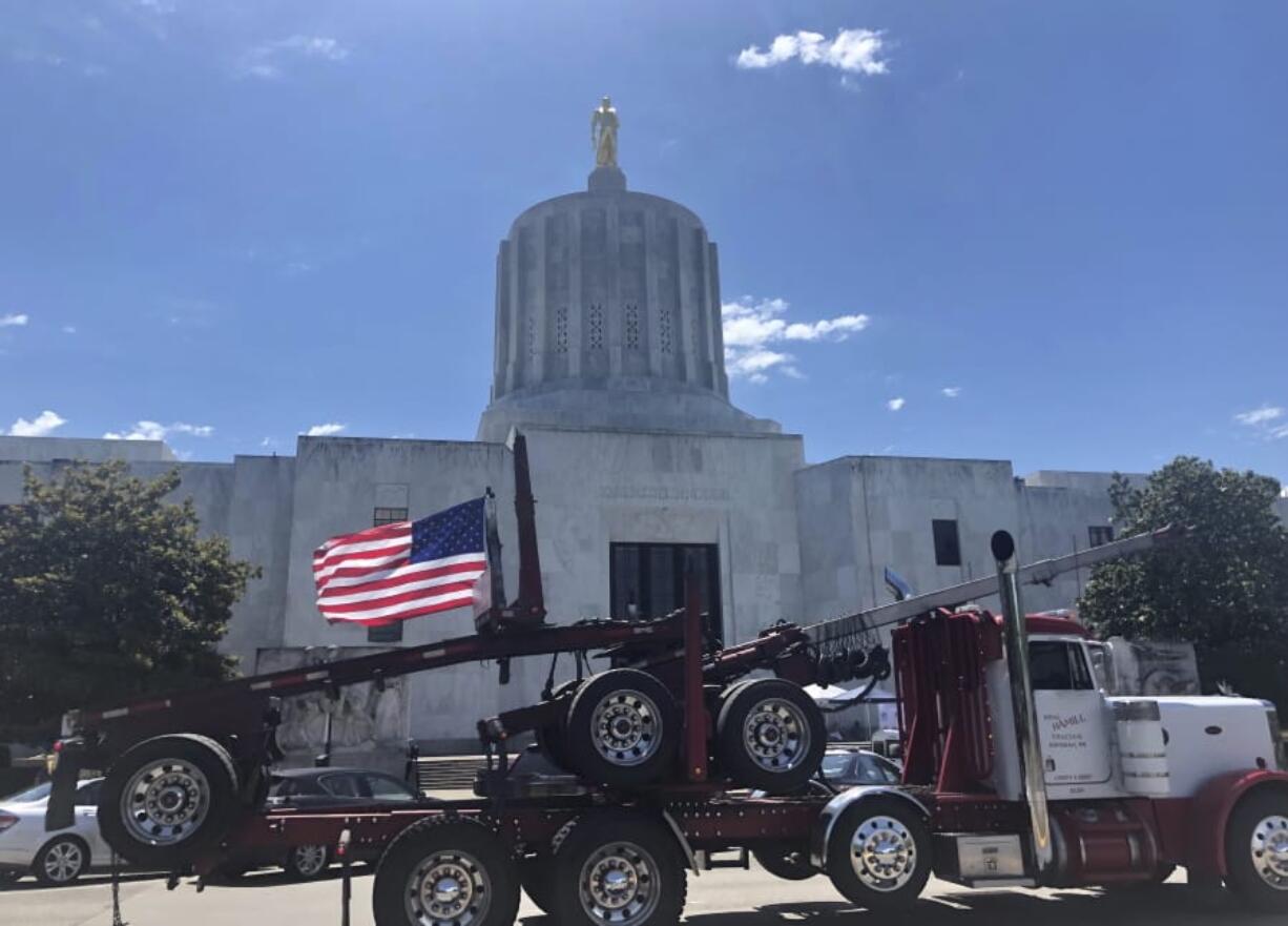 A heavy-duty truck drives around the Oregon state Capitol during a protest Wednesday in Salem, Ore.