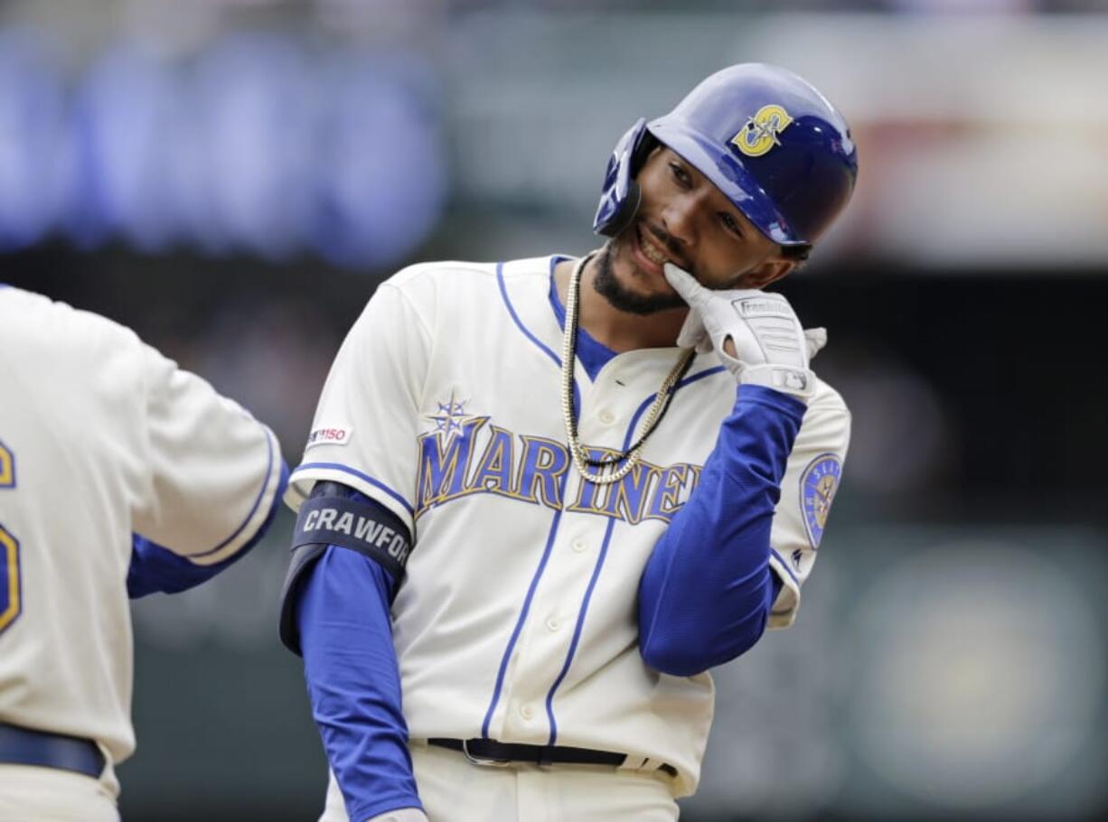 Seattle Mariners’ J.P. Crawford reacts on first after hitting a two-run single against the Baltimore Orioles during the third inning of a baseball game, Sunday, June 23, 2019, in Seattle.