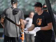 Baltimore Orioles first-round draft pick Adley Rutschman stands on the field during during batting practice before a baseball game against the San Diego Padres, Tuesday, June 25, 2019, in Baltimore.