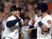 Houston Astros’ George Springer, left, celebrates with Alex Bregman (2) after hitting a home run against the Pittsburgh Pirates during the first inning of a baseball game Wednesday, June 26, 2019, in Houston. (AP Photo/David J.