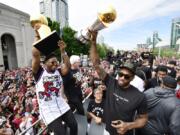 Toronto Raptors guard Kyle Lowry, left, holds the Larry O’Brien Championship Trophy as forward Kawhi Leonard holds his playoffs MVP trophy during the NBA basketball championship team’s victory parade in Toronto, Monday, June 17, 2019.