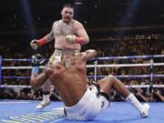 Andy Ruiz knocks down Anthony Joshua during the third round of a heavyweight title boxing match Saturday, June 1, 2019, in New York. Ruiz won in the seventh round.