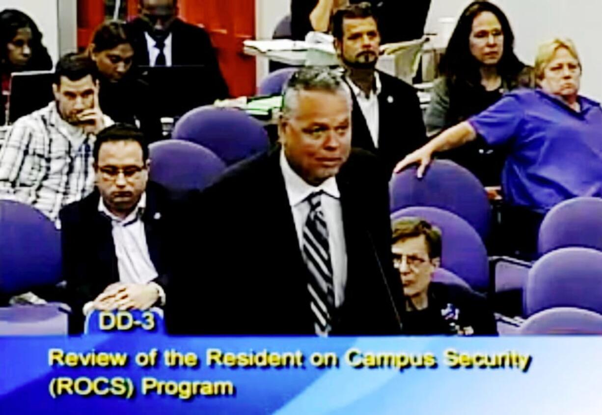 FILE - In this Feb. 18, 2015, file frame from video from Broward County Public Schools, school resource officer Scot Peterson talks during a school board meeting of Broward County, Fla. Peterson, the then-Florida sheriff’s deputy assigned to protect the high school where 17 died in a 2018 shooting has been arrested on 11 charges, Tuesday, June 4, 2019. State Attorney Mike Satz announced that 56-year-old Peterson faces child neglect, culpable negligence and perjury charges.