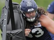 Seattle Seahawks center Joey Hunt hits a blocking sled as he runs a drill, Thursday, June 6, 2019, at the team’s NFL football training facility in Renton, Wash. (AP Photo/Ted S.