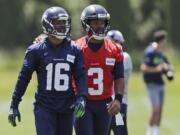 Seattle Seahawks quarterback Russell Wilson (3) walks off the field with wide receiver Tyler Lockett (16) following an organized team activity Tuesday, June 4, 2019, at the team’s NFL football training facility in Renton, Wash. (AP Photo/Ted S.