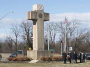 FILE - In this Feb. 13, 2019 file photo, visitors walk around the 40-foot Maryland Peace Cross dedicated to World War I soldiers in Bladensburg, Md. The Supreme Court says the World War I memorial in the shape of a 40-foot-tall cross can continue to stand on public land in Maryland. The high court on Thursday rejected a challenge to the nearly 100-year-old memorial. The justices ruled that its presence on public land doesn’t violate the First Amendment’s establishment clause.