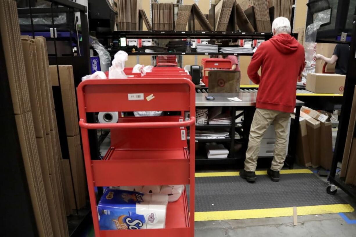 An assembly line worker packages items from an online order to be shipped out of a Target store in November in Edison, N.J. Target is offering same-day delivery on thousands of items for $9.99 per order through a delivery startup it purchased nearly two years ago.