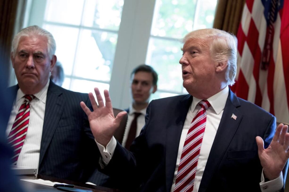 FILE - In this June 12, 2017, file photo, then-Secretary of State Rex Tillerson, left, and White House senior adviser Jared Kushner listen as President Donald Trump speaks during a Cabinet meeting in the Cabinet Room of the White House in Washington. Tillerson has told Congress that an awkward encounter with Kushner in a Washington restaurant was an example of diplomacy being conducted behind his back when he was in the administration.