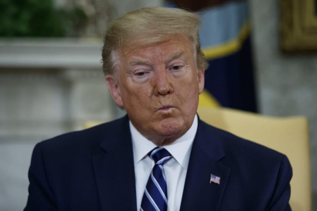 President Donald Trump listens to a question during a meeting with Canadian Prime Minister Justin Trudeau in the Oval Office of the White House, Thursday, June 20, 2019, in Washington.