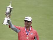 Gary Woodland celebrates with the trophy after winning the U.S. Open Championship golf tournament Sunday, June 16, 2019, in Pebble Beach, Calif.