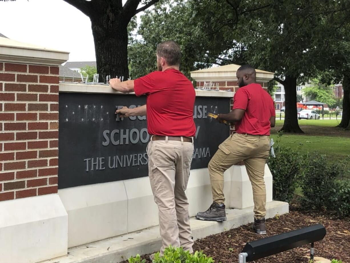 University of Alabama employees remove the name of Hugh F. Culverhouse Jr. off the School of Law sign in Tuscaloosa, Ala., Friday, June 7, 2019. The University of Alabama board of trustees voted Friday to give back a $26.5 million donation to a philanthropist Hugh F. Culverhouse Jr., who recently called on students to boycott the school over the state’s new abortion ban.