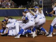 UCLA players celebrates after defeating Oklahoma in the NCAA softball Women’s College World Series in Oklahoma City, Tuesday, June 4, 2019. UCLA won 5-4 in Game 2, taking both games in the best-of-three series.