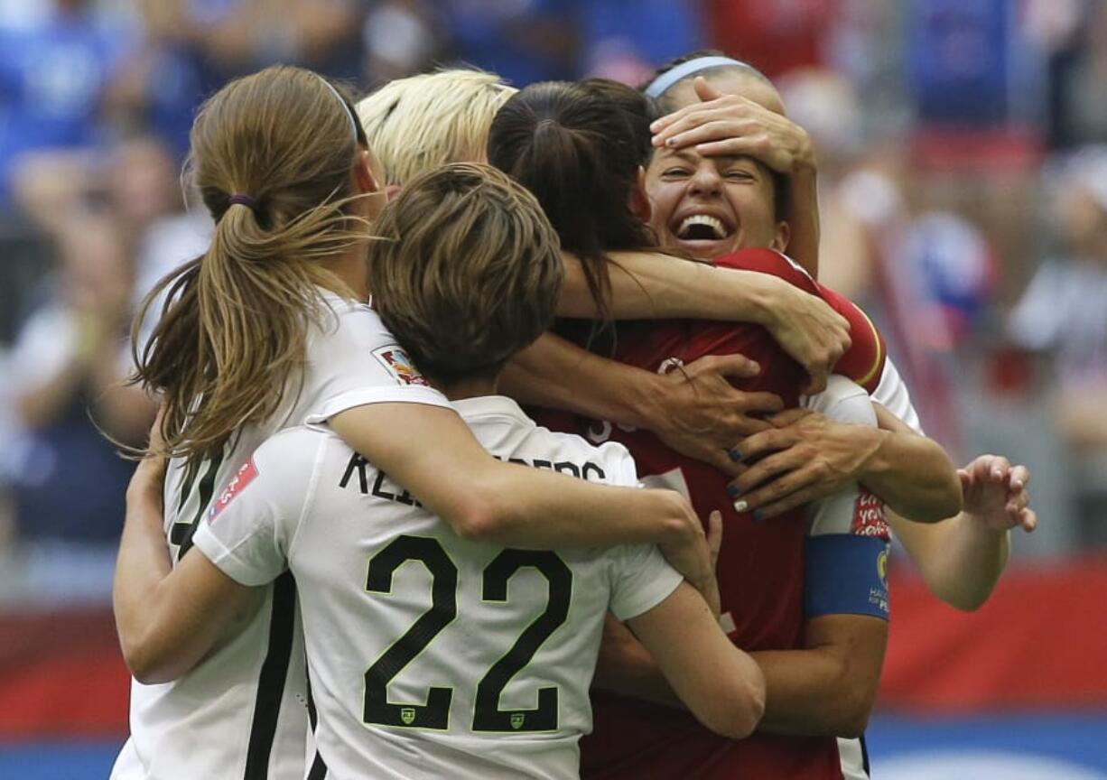 United States’ Carli Lloyd, right, celebrates with teammates during the 2015 championship match. The U.S. national team, ranked No. 1 globally, will try to defend its title in soccer’s premier tournament, which kicks off on June 7.