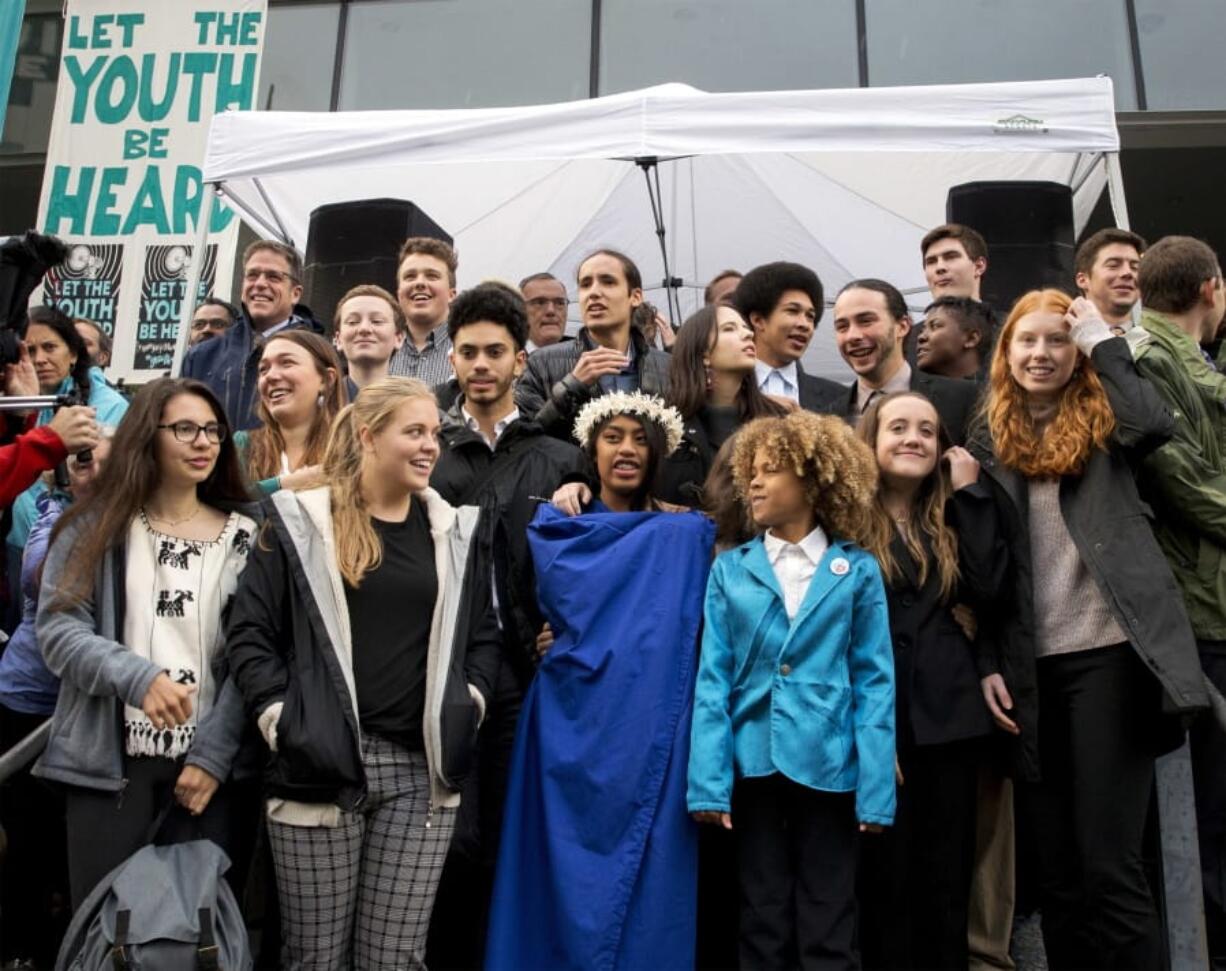 Young plaintiffs stand on the steps of the United States District Courthouse during a rally Oct. 29 in Eugene, Ore., to support a high-profile climate change lawsuit against the federal government. A lawsuit by a group of young Americans accusing the U.S. government of harming them by having fostered a fossil-fuels energy system faces a major hurdle Tuesday when a federal appeals court hears oral arguments on whether the case should proceed.