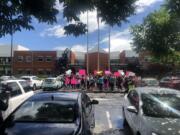 Students gather outside Heritage High School on Friday in a show of solidarity with a student who claimed school officials were turning a blind eye to bullying, harassment and sexual assault on campus.