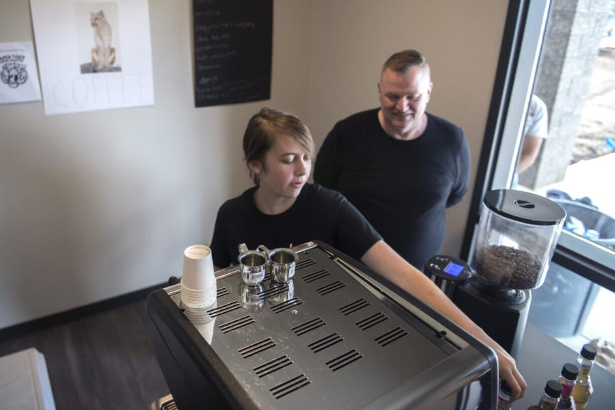 Autumn Hardy with the Bridgeview barista-training program makes a latte during an open house for the Caples Terrace, an apartment complex for homeless youth and youth aging out of foster care. Hardy said she’s recommended the experience to friends who, like her, don’t have much to do in the summer.