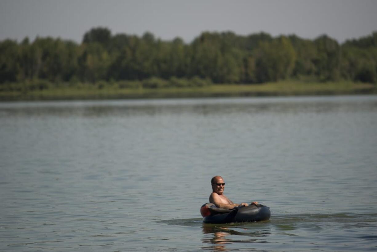 Don Wood of Vancouver floats on his inner tube on Vancouver Lake earlier in July.