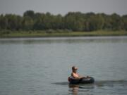 Don Wood of Vancouver floats on his inner tube on Vancouver Lake earlier in July.