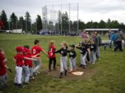 Two East County Little League teams high-five after their game May 21 at George Schmid Memorial Park in Washougal. The park will get a third baseball field thanks to a state grant.