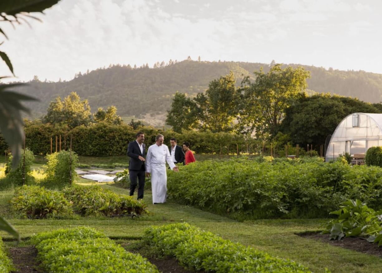 French Laundry chef Thomas Keller shows guests through the three-acre Culinary Garden across the street.