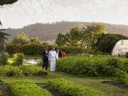 French Laundry chef Thomas Keller shows guests through the three-acre Culinary Garden across the street.