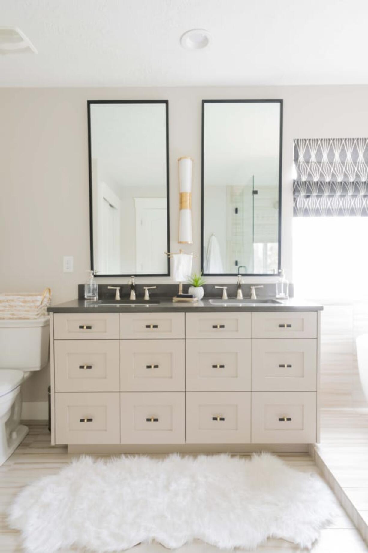 Drawing the eye upward with tall mirrors can open up a small, cramped bathroom.