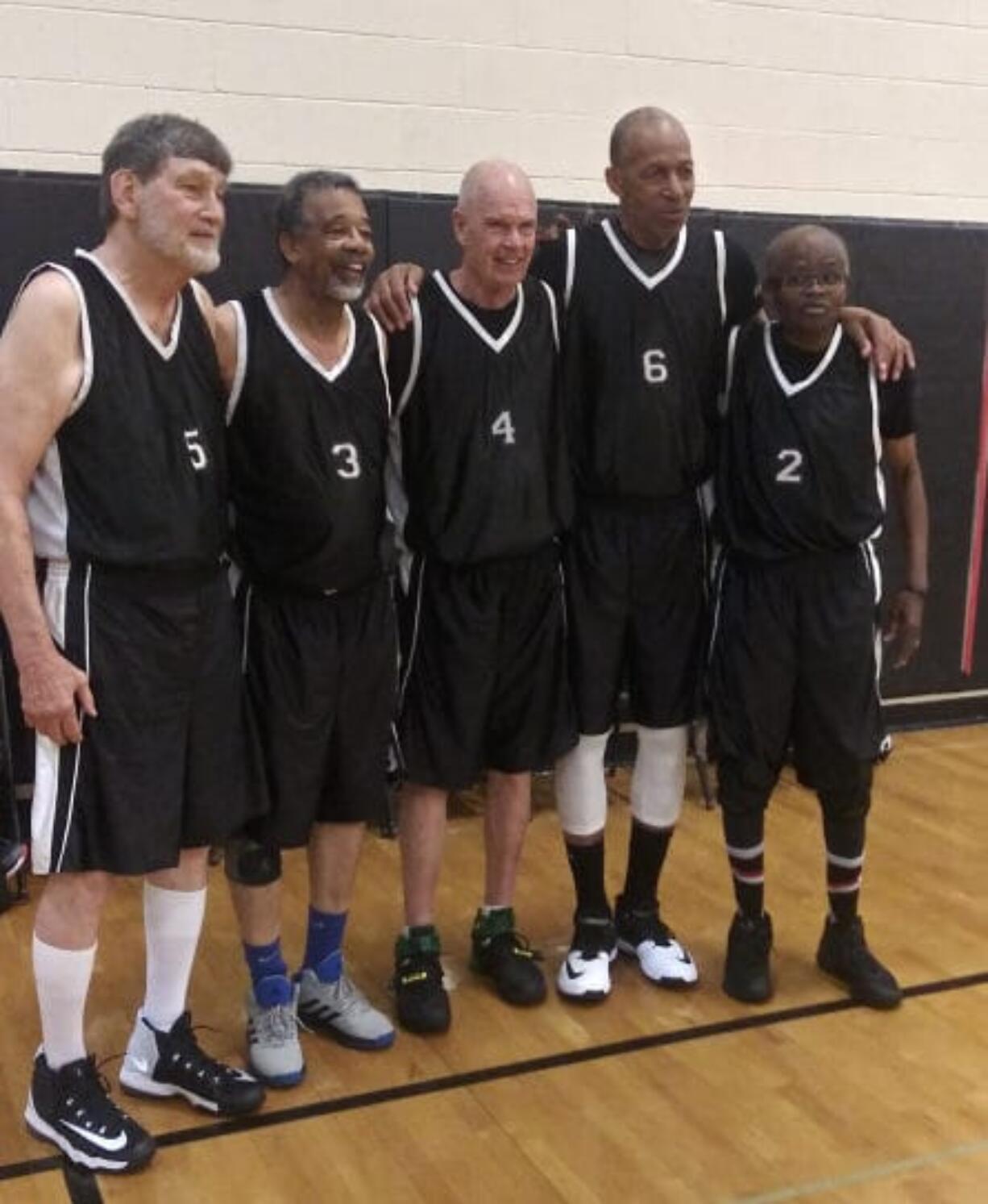 Battle Ground’s Jim Nielsen, center, stands with his teammates during the National Senior Games last month in Albuquerque, N.M.