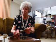 Edith Bonsonto goes through a scrap book with photos of her husband Gerald. Thursday, June 27, 2019, in Orland Park.