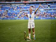 United States’ forward Megan Rapinoe poses with the trophies after the France 2019 Womens World Cup football final match between USA and the Netherlands, on July 7, 2019, at the Lyon Stadium in Lyon, central-eastern France.