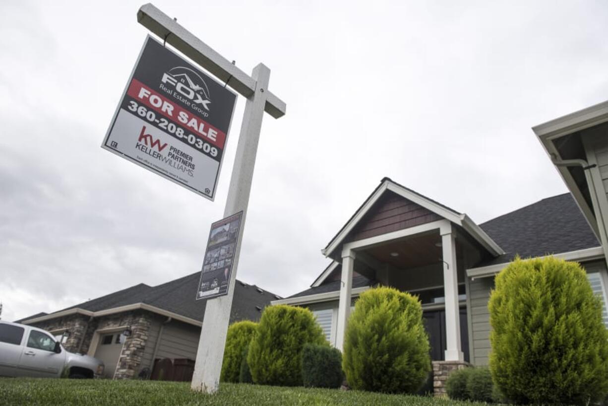 A for-sale sign in front of a home in Felida in May. Sales and listings cooled off a bit in June, according to the latest RMLS Market Action report.