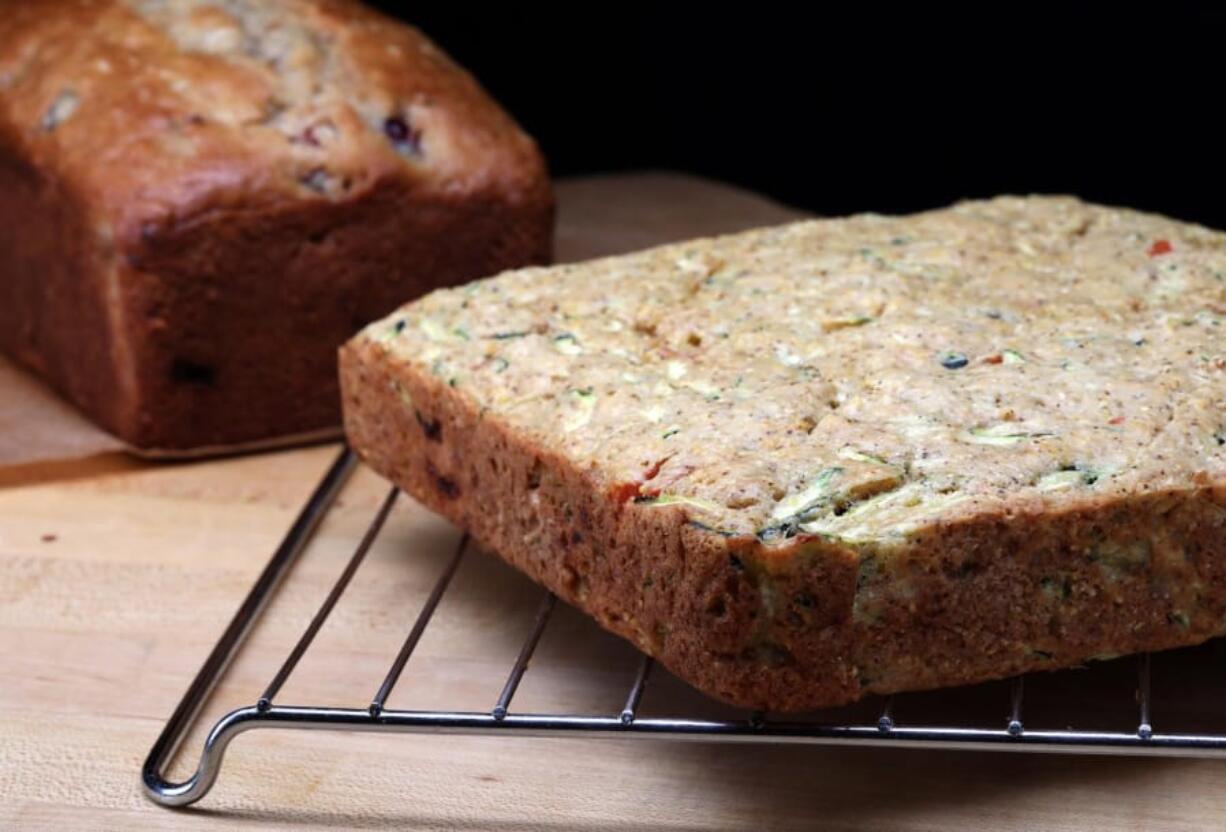 Summer quick breads, left, with cherries and almonds, and right, cornbread with tomatoes, are seen in the Tribune studio on Wednesday, July 3, 2019.