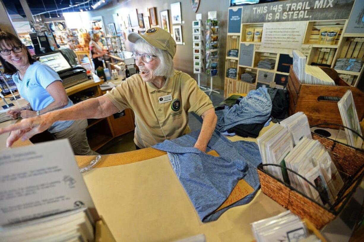 Kathryn Mills, 89, waves goodbye to a customer during a volunteer shift this month at the Trail Mix store in Peninsula, Ohio.