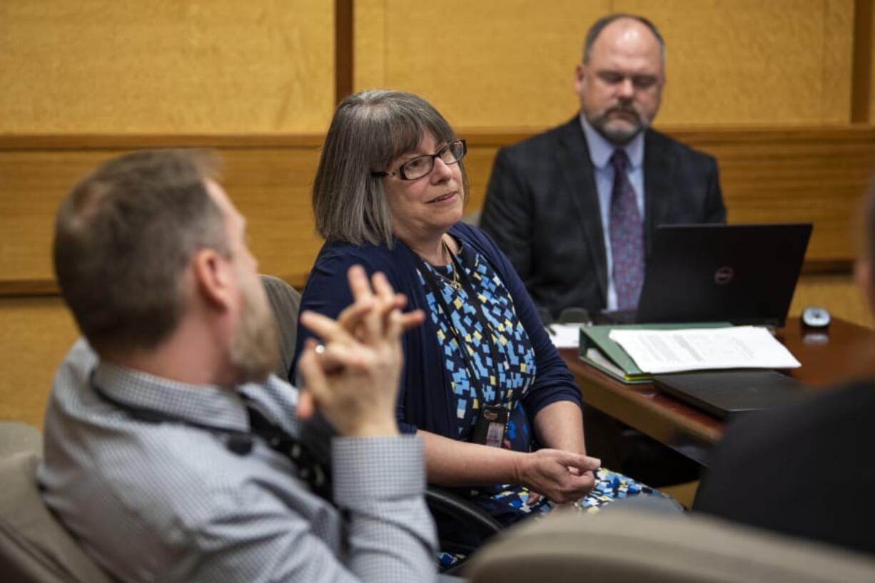 Therapeutic Specialty Courts Coordinator Beth Robinson, center, speaks about the changes to veterans court June 10 in Clark County District Court.