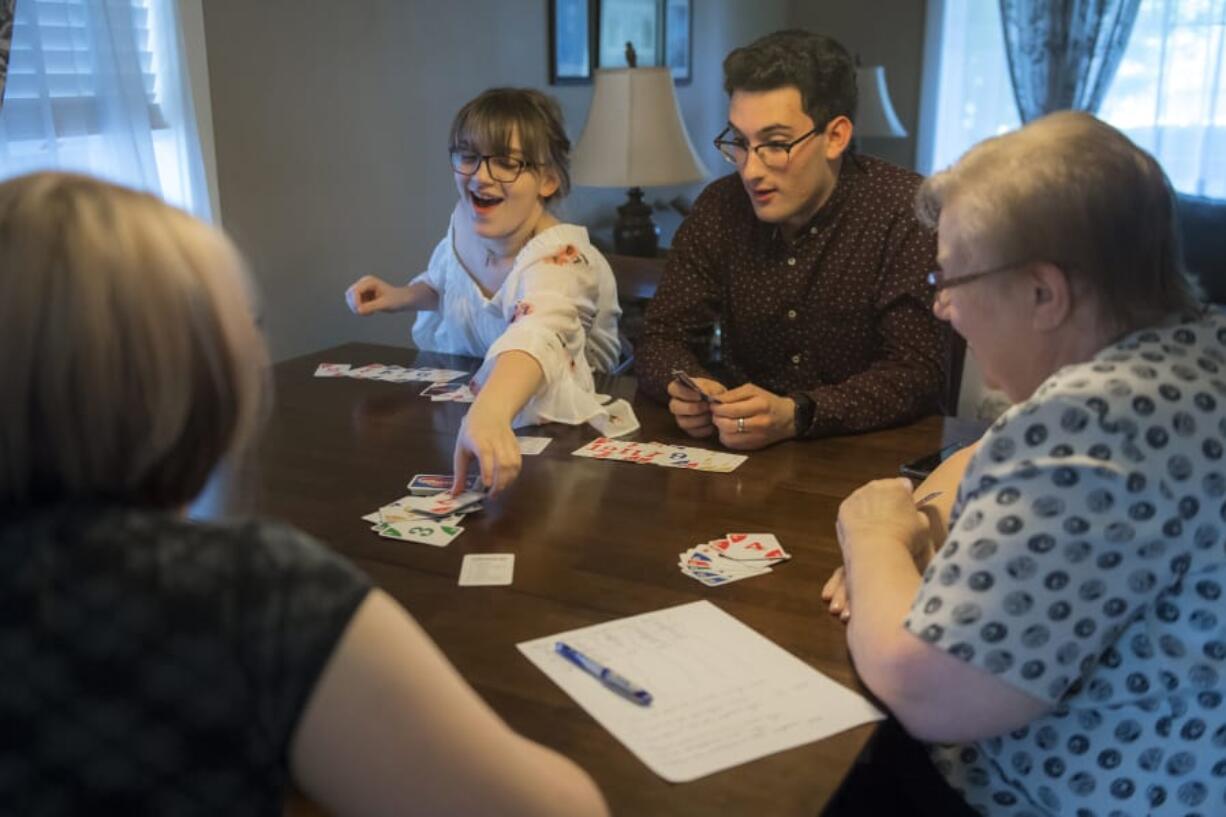 Kylie Sickles and Jorge Vicente react as Sickles plays her last card in a game of Phase 10 at the Sickles’ home in Salmon Creek in June. Vicente spent his junior year at Skyview High School as an exchange student.