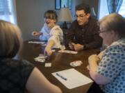 Kylie Sickles and Jorge Vicente react as Sickles plays her last card in a game of Phase 10 at the Sickles’ home in Salmon Creek in June. Vicente spent his junior year at Skyview High School as an exchange student.